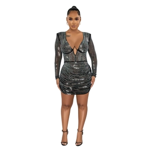 Detail of black mesh mini dress featuring shimmering silver rhinestones and deep V-neck