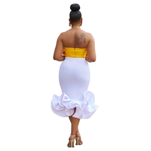 Back view of elegant two-piece set featuring yellow crop top and white ruffled mermaid skirt