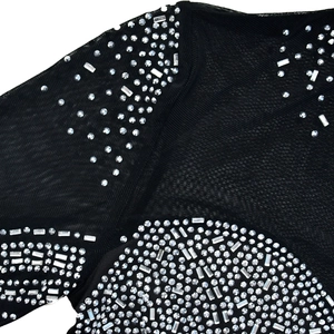 Detail of sheer black mesh fabric with sparkling silver rhinestones and crystal decor