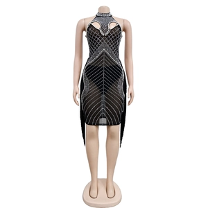 Close-up of black mesh halter dress featuring sparkling rhinestones and elegant fringe hem