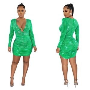 Detail of green mesh dress featuring sparkling rhinestones and deep V-neckline