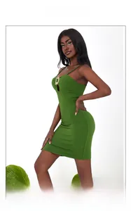 Detail of green bodycon dress featuring sun-shaped metal ornament and cutout chest design