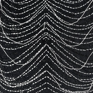 Macro shot of black mesh dress featuring intricate silver sequins and beadwork details