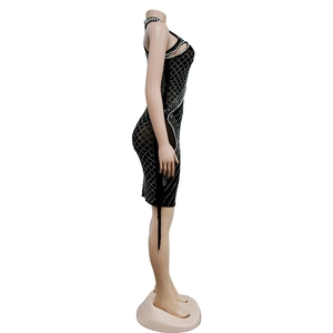 Close-up of black mesh dress featuring silver rhinestone diamond grid and cut-out detail