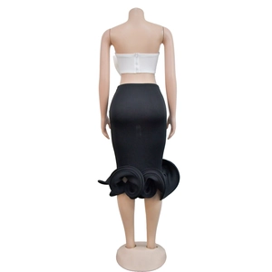 Detailed back view of white strapless top with metal zipper and black fishtail skirt
