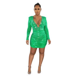 Close-up of vibrant green bodycon dress with silver sequins and ruched detail
