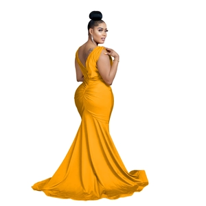 Detail of elegant V-neck back and pleated waist on a flowing yellow satin maxi dress
