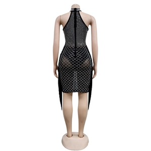 Detail of black halter dress featuring sparkling rhinestones, pearls, and fringe hem