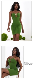 Detail of green bodycon dress featuring hollow cutout and gold sun-shaped metal buckle
