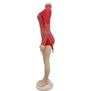 Detail of red mesh rhinestone bodysuit featuring long sleeves and sparkling crystal accents