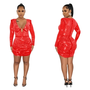 Close-up of red bodycon dress featuring sparkling rhinestones and elegant ruched detailing