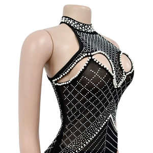 Detailed view of black mesh bodysuit featuring halter neck with pearls and rhinestones
