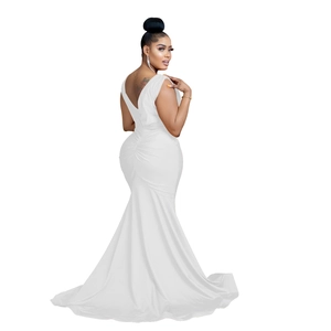 Detail view of the sleek back design with pleated waist and elegant white fishtail train
