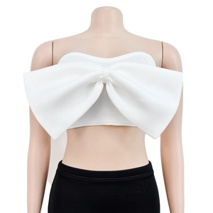 Detailed view of the white strapless tube top featuring a large decorative bow design