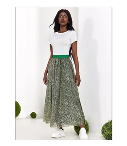 Close-up of green floral high-waist maxi skirt with elastic waistband and leopard print