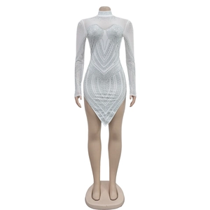 Close-up of white mesh dress featuring dense silver rhinestones and asymmetric hemline