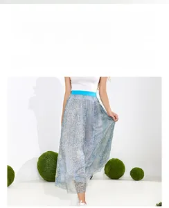 Detail of high waisted pleated wide leg skirt with metallic gold wave texture fabric