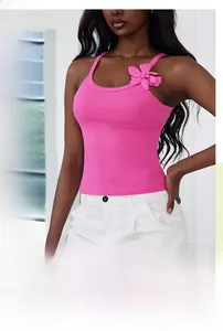 Detail of pink knitted crop top featuring handmade 3D floral accents on the straps