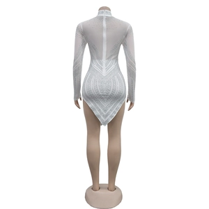 Detail of white mesh dress featuring shimmering silver rhinestones and back zipper