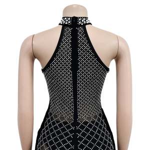 Detail of black halter dress featuring a pearl neckline and diamond mesh pattern with zipper