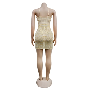 Detailed view of champagne bodycon mini dress featuring intricate rhinestone patterns