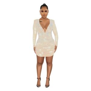Detail of apricot mini dress featuring silver rhinestones and sexy deep V-neck cutout design