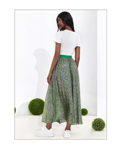 Detail view of high-waist A-line green skirt with gold floral print and matching belt
