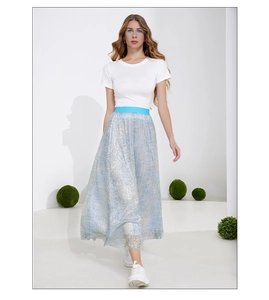 Detail of high waist pleated skirt with shiny metallic fabric and elastic blue waistband