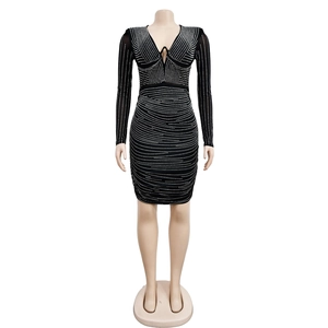 Close-up detail of rhinestones on black long sleeve bodycon dress with V-neckline