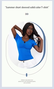 Detail of blue U-neck cropped tee with pleated chest and decorative button