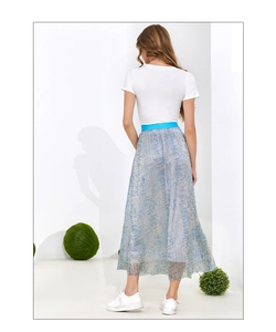 Detail of high waist light blue pleated skirt with gold glitter and metallic shine