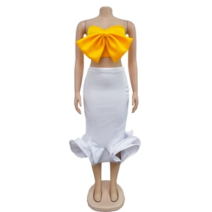Detailed view of yellow bow tube top and white ruffled fishtail skirt two-piece set