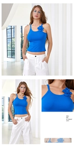 Detail view of blue crop top with a large decorative 3D flower and ribbed texture fabric