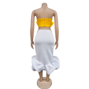 Rear view of yellow strapless top with bow detail and white fishtail skirt set
