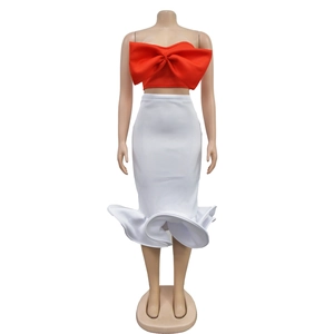 Detail of red bow tube top and white high-waist skirt with asymmetrical ruffled hem