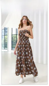 Detail of tiered floral maxi dress with smocked bodice and bohemian sun pattern