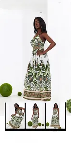 Detail view of summer dress with green palm leaves, floral print and ethnic embroidery bands