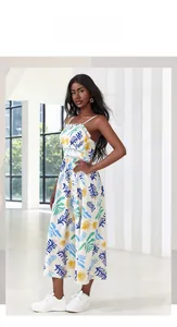 Detail of tropical leaf print on lightweight and breathable white chiffon dress