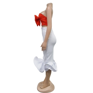 Side view of red strapless bow top and white fishtail skirt set for women