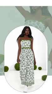Detail of white maxi dress featuring green shell coral prints and wave ribbon trim edges