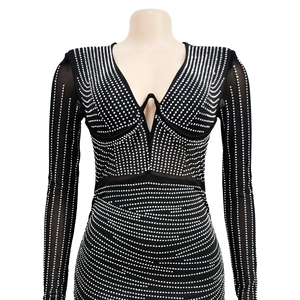 Detail of black V-neck dress featuring sparkling silver rhinestones and mesh texture