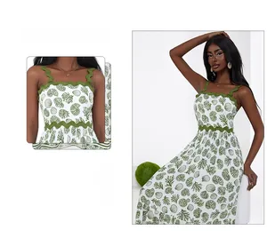 Detail of scalloped neckline and green sea life print on a white summer sundress