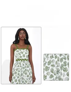 Detail of nautical coral print and green scalloped trim on white summer dress