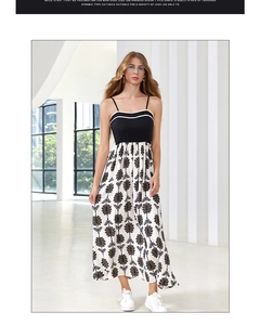 Detail of the elegant black and white patchwork dress with retro floral print and thin straps