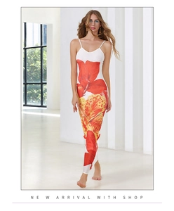 Détail de l'imprimé floral tropical rouge et jaune sur une robe longue d'été blanche