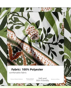 Detail of 100% polyester fabric with green leaf and orange flower print for summer dress