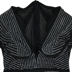Detailed view of deep V-neckline on mesh dress with silver rhinestones and zipper