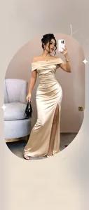 Detail of apricot satin dress showing off-shoulder neckline and elegant waist pleats