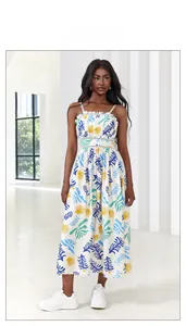 Detail of white midi dress featuring blue floral print, ruffled neckline and waist cut-out