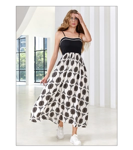 Detailed view of elegant summer patchwork dress featuring floral print and light fabric